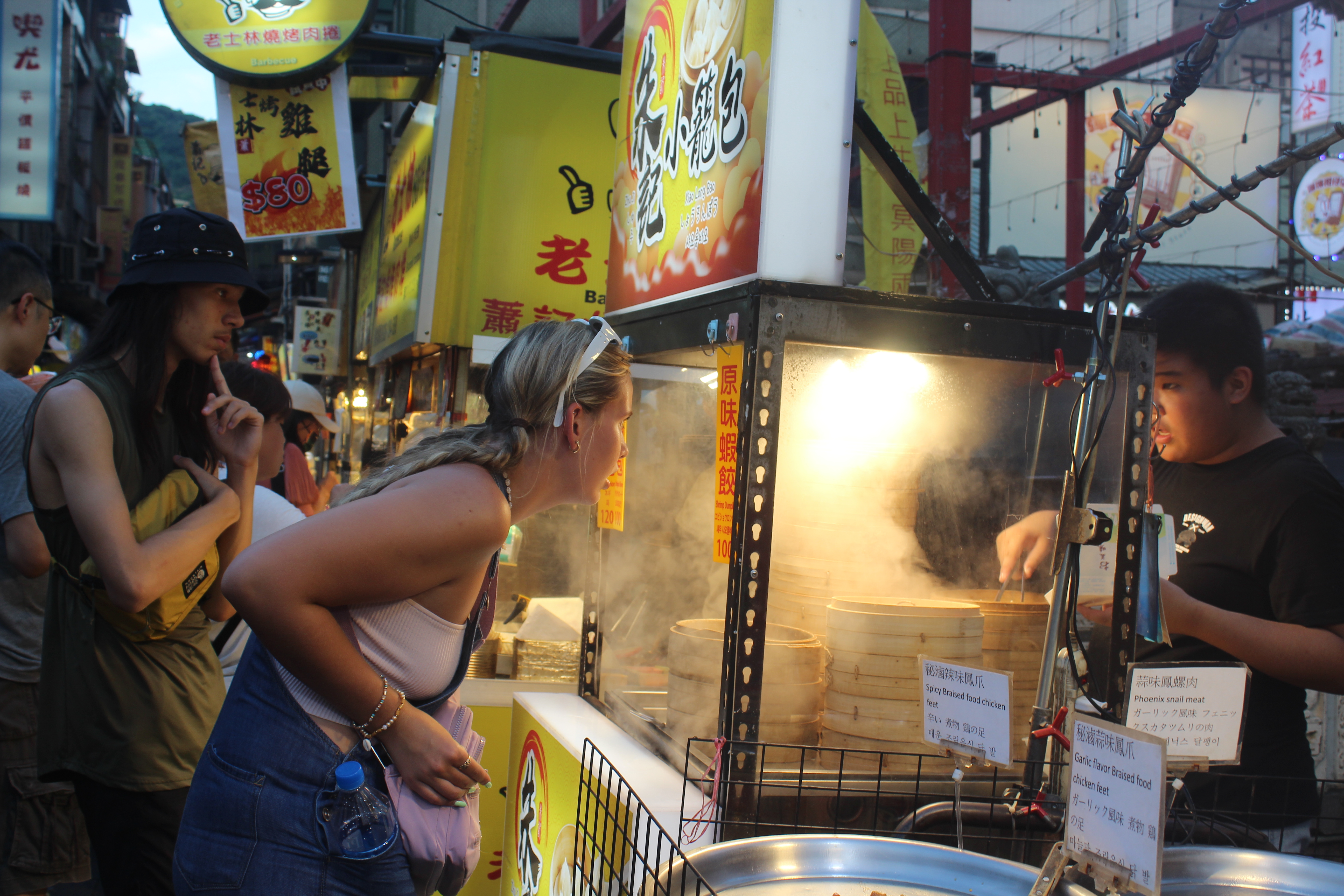 Students enjoying street food at a night market in Taiwan